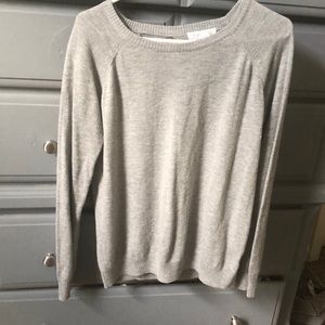 Light gray sweater with fun back detail.